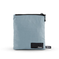 packed up slate poncho on white background