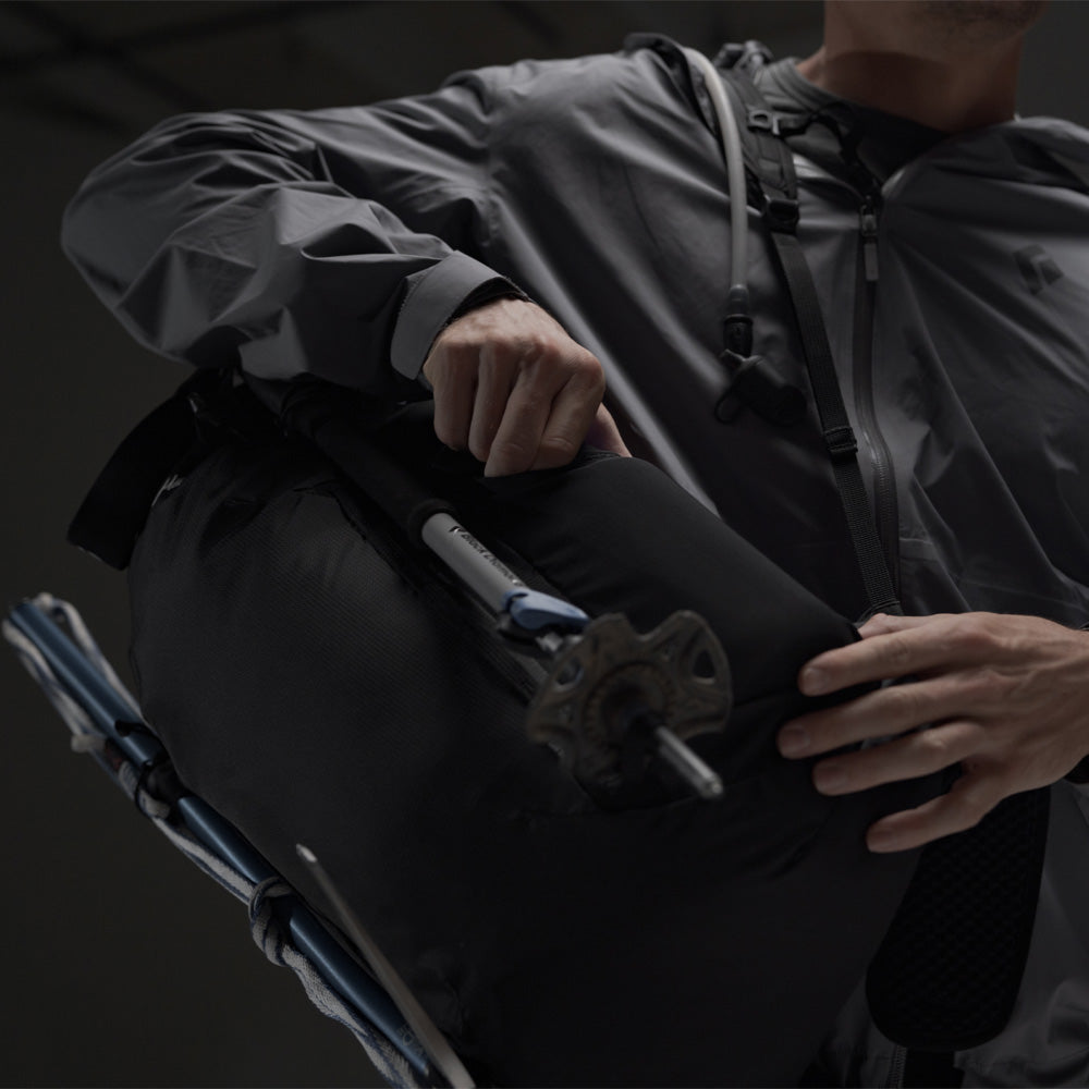 Man pulling water bottle out of Beast28 backpack