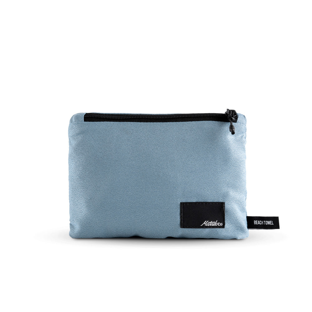 Packed up slate blue towel on white background