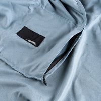 Close up view of zipper pocket on slate blue towel