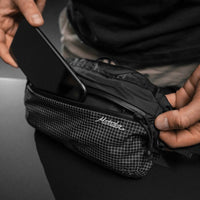 Placing cell phone in hip pack front pocket