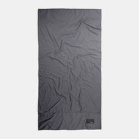 Top-down view of full charcoal towel on light gray background