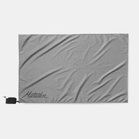 Pocket Blanket Mini laid flat on a light gray background