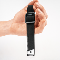 Close up of hand holding single black gear tag by finger