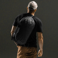 Man wearing duffle across his back