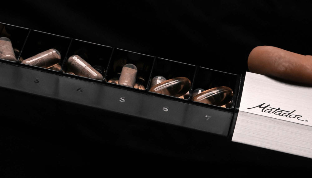 close up view of open pill canister, showing numbers on the side of each slot