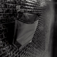 Open FlatPak Toiletry Case hanging on shower hook from hang loop