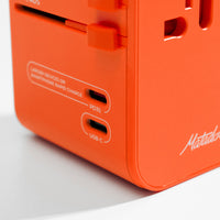 close up view of PD35 and USB-C ports on orange travel adapter